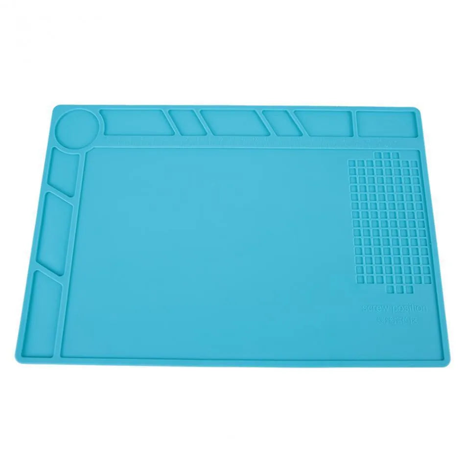 Blue silicone anti-skid watch repair mat on a workbench for horology tools.