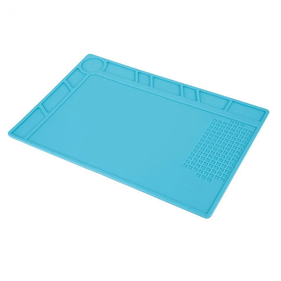 Blue silicone anti-skid watch repair mat on a workbench for horology tools.