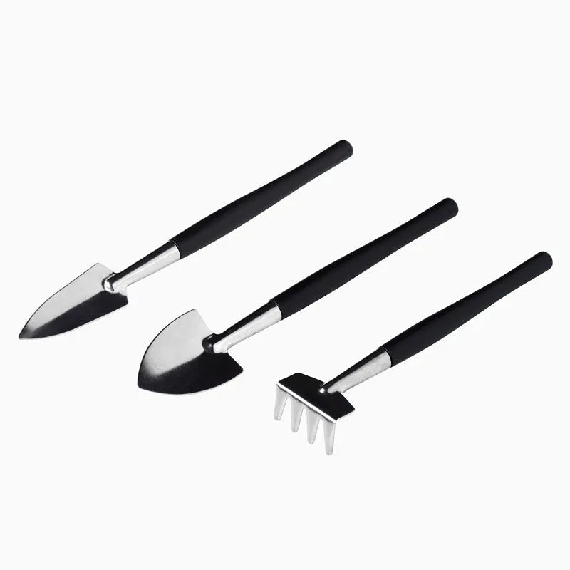Black plastic and metal mini garden tool set for succulents with 15 pieces including scissors, tweezers, shovels, and a square cushion.