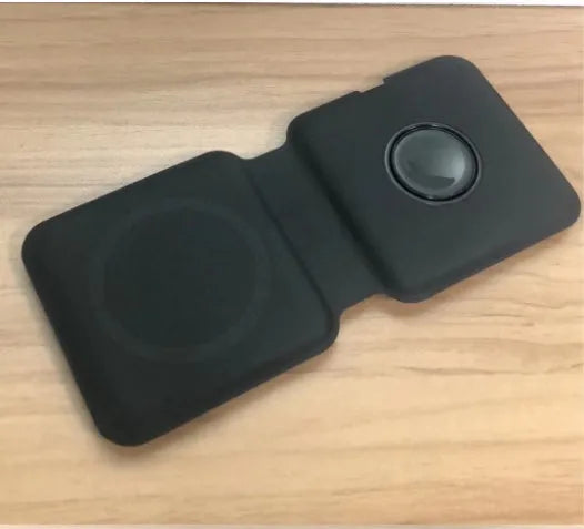 White folding dual magnetic wireless charging dock shown in stand mode with a phone attached.