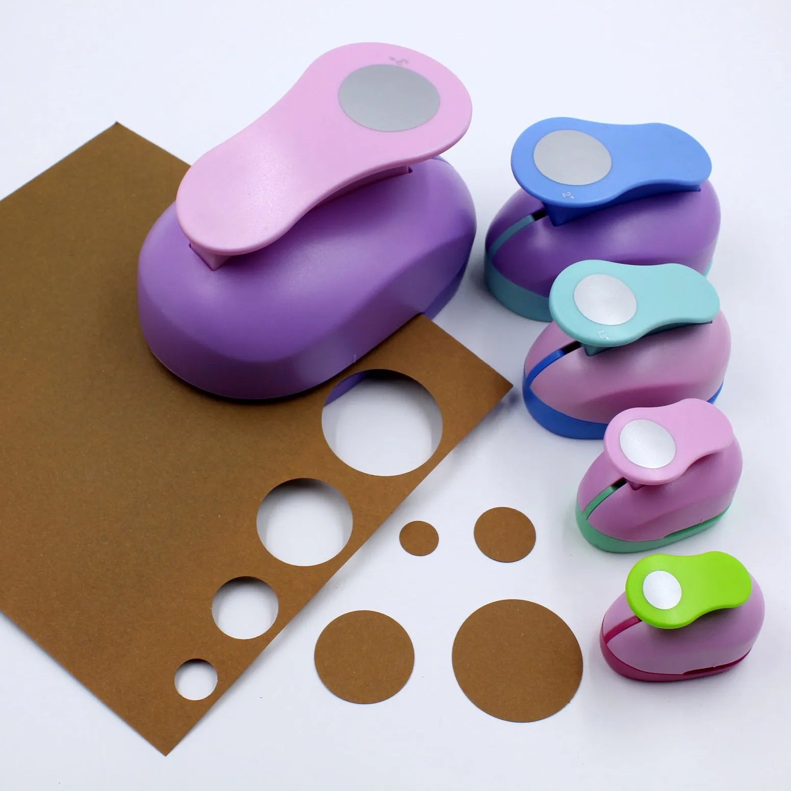 Colourful round children's puzzle embossing machine with six disc sizes on a card.