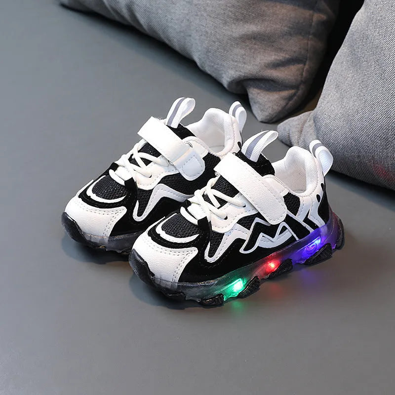 Children's black Velcro sneakers with breathable mesh panels and a rubber sole.