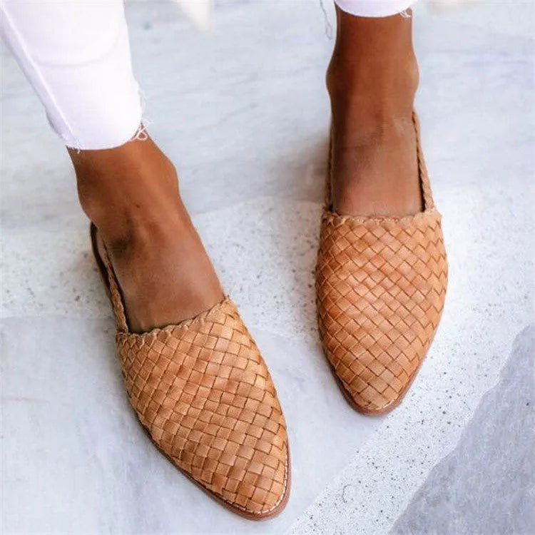 A pair of flat, pointed-toe sandals with a buckle fastening, shown in a choice of colours.