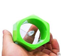 Yellow and green plastic spiral vegetable cutter for cucumbers on a kitchen counter.