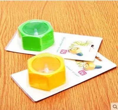 Yellow and green plastic spiral vegetable cutter for cucumbers on a kitchen counter.