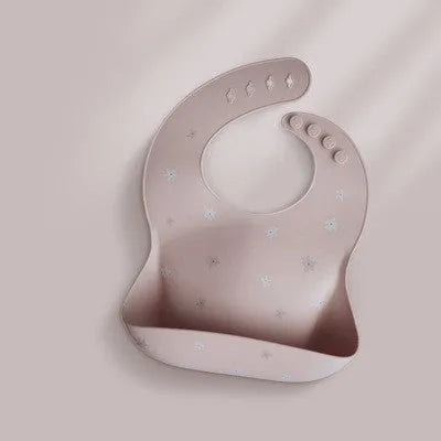 Pink baby waterproof silicone feeding bib with deep pocket and white daisy pattern