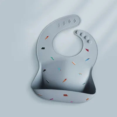 Pink baby waterproof silicone feeding bib with deep pocket and white daisy pattern