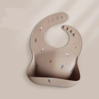 Pink baby waterproof silicone feeding bib with deep pocket and white daisy pattern