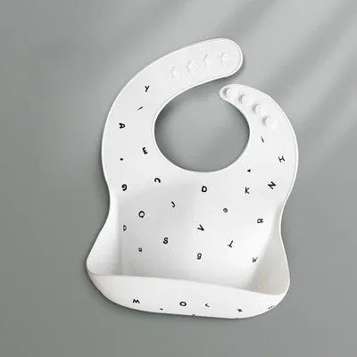 Pink baby waterproof silicone feeding bib with deep pocket and white daisy pattern