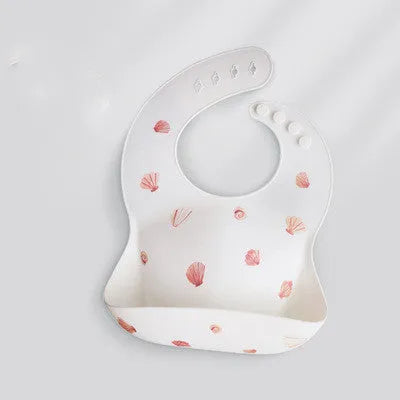 Pink baby waterproof silicone feeding bib with deep pocket and white daisy pattern