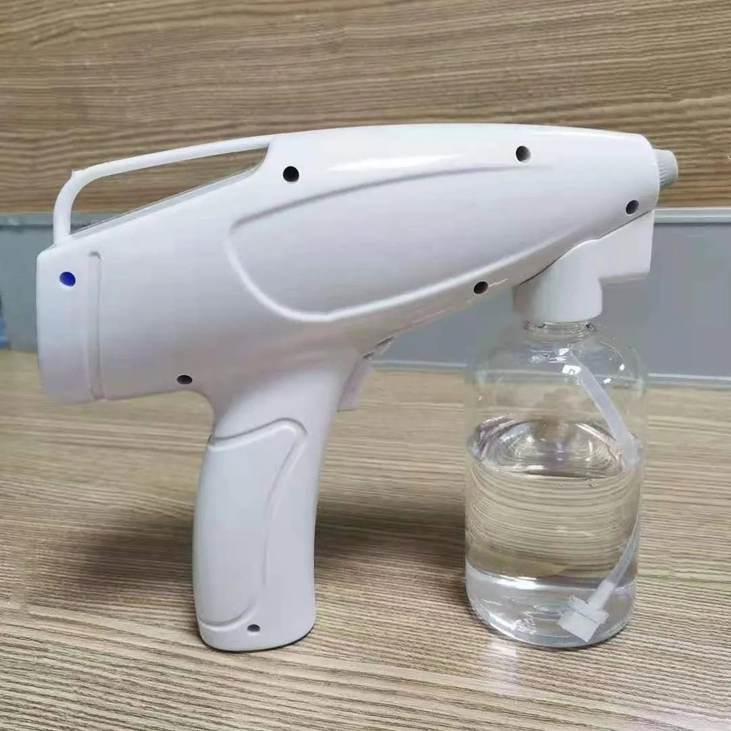 White handheld cordless electric disinfectant spray gun with bottle attached on a white background.