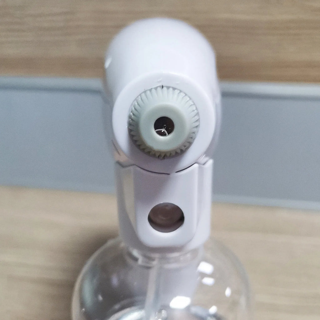 White handheld cordless electric disinfectant spray gun with bottle attached on a white background.