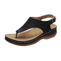 Women's black wedge heel sandals with an adjustable buckle back strap on a plain background.