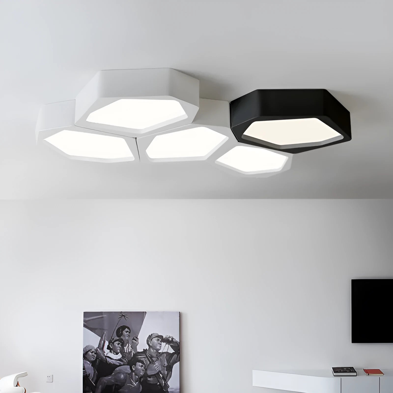 Geometric shaped black and white iron LED ceiling light with remote control on a table