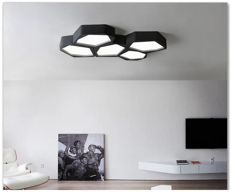 Geometric shaped black and white iron LED ceiling light with remote control on a table