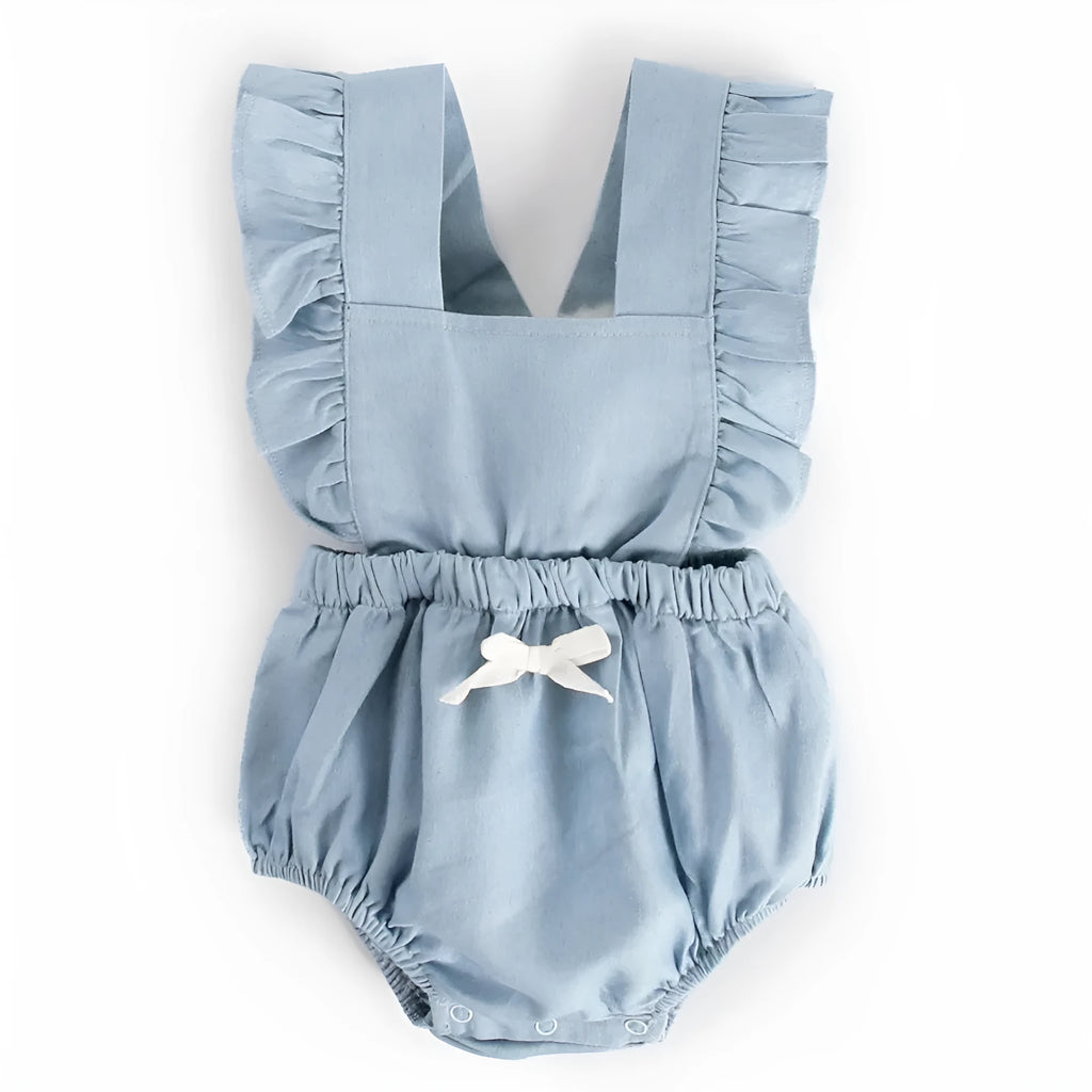Blue denim sleeveless baby romper with lace detail and triangle neckline on a hanger.