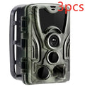 Green cellular trail hunting camera showing front lens and display on a tree mount.