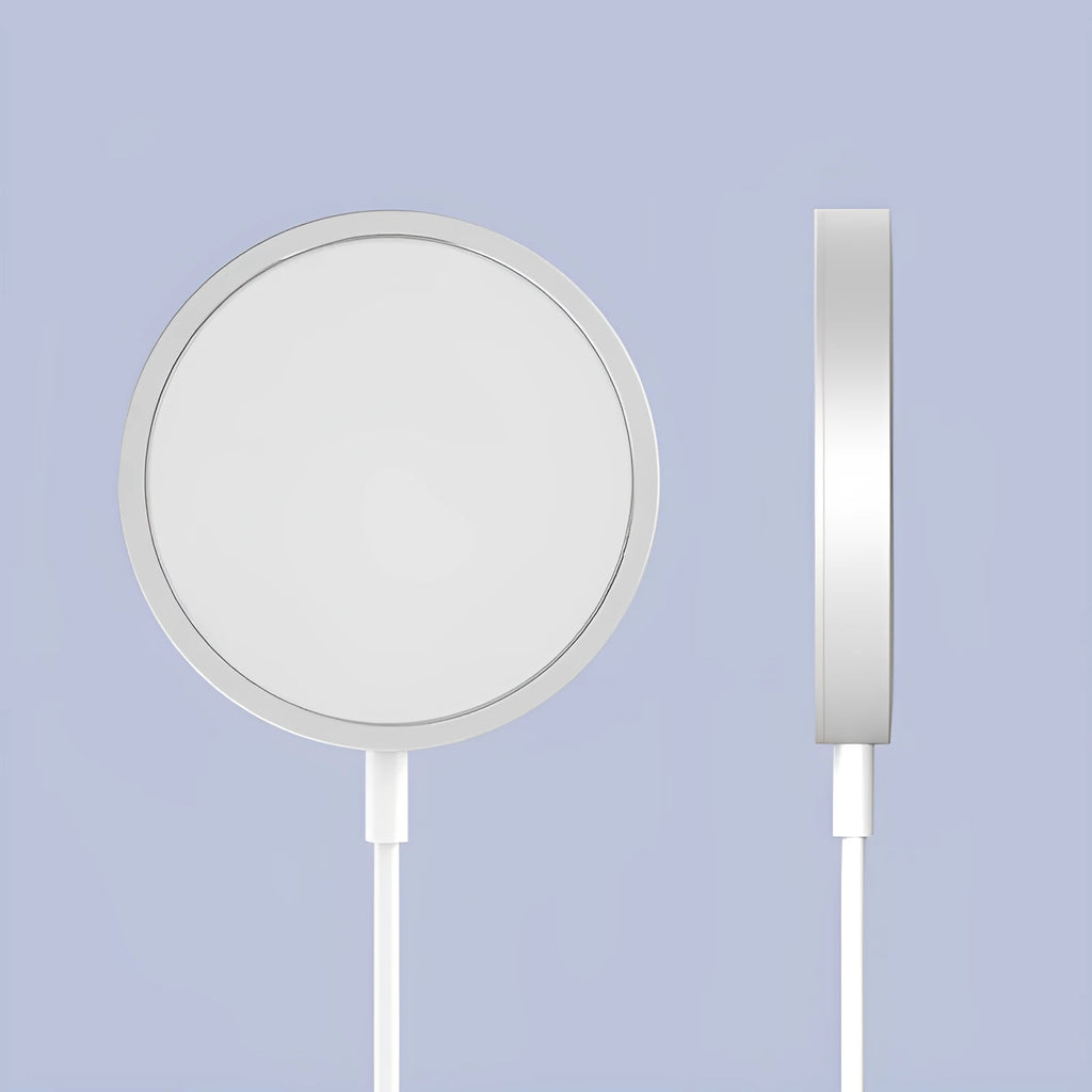 Silver metal magnetic wireless charger for iPhone on a wooden desk.