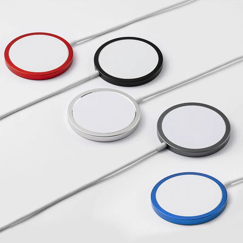 Silver MagSafe magnetic wireless charger for iPhone on a desk next to an iPhone.