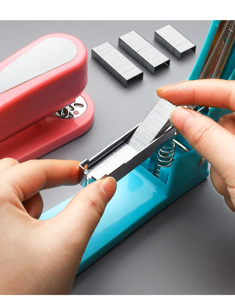 A rotatable student stapler with a 360° spinning head, shown in blue on a desk with papers.