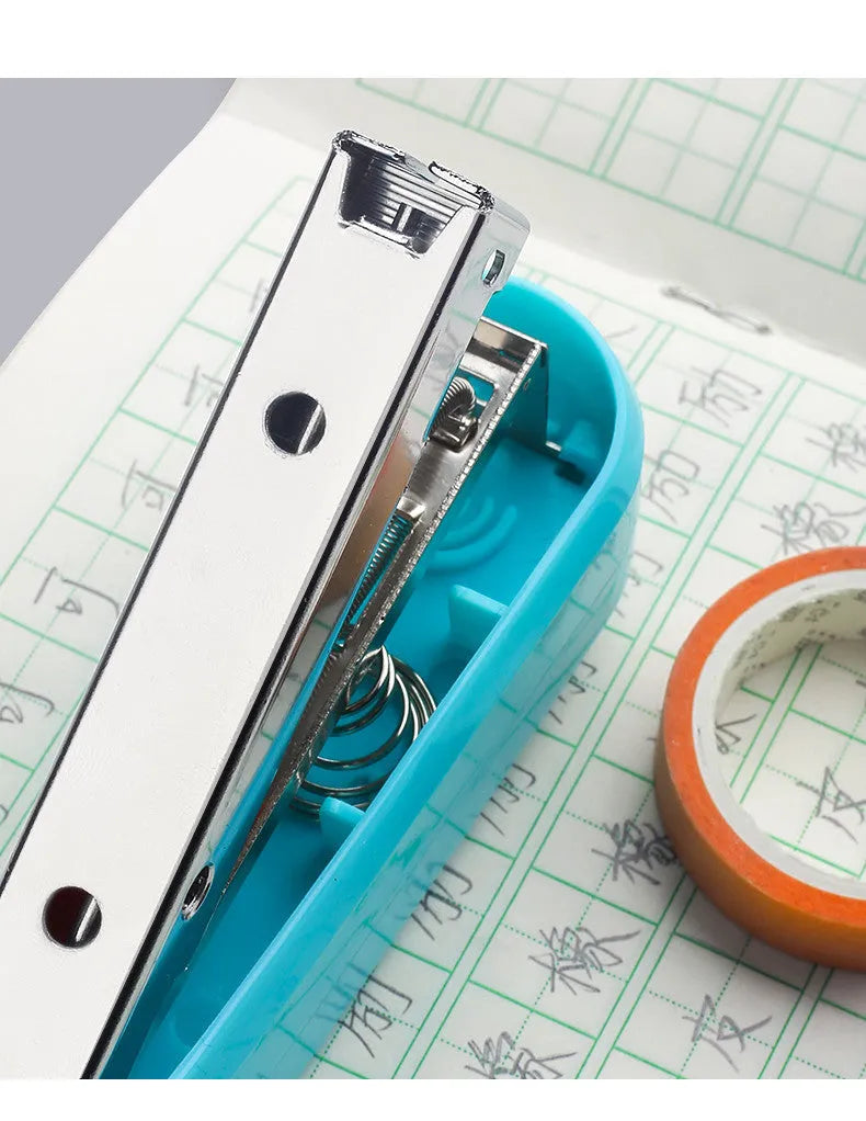 A rotatable student stapler with a 360° spinning head, shown in blue on a desk with papers.