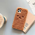 Brown TPU iPhone case with an embroidered plush cartoon bear face on the back.