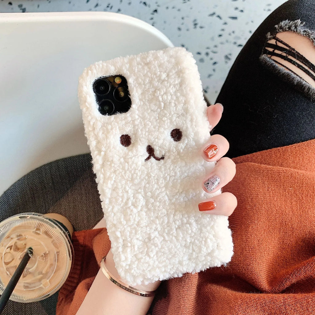 Brown TPU iPhone case with an embroidered plush cartoon bear face on the back.