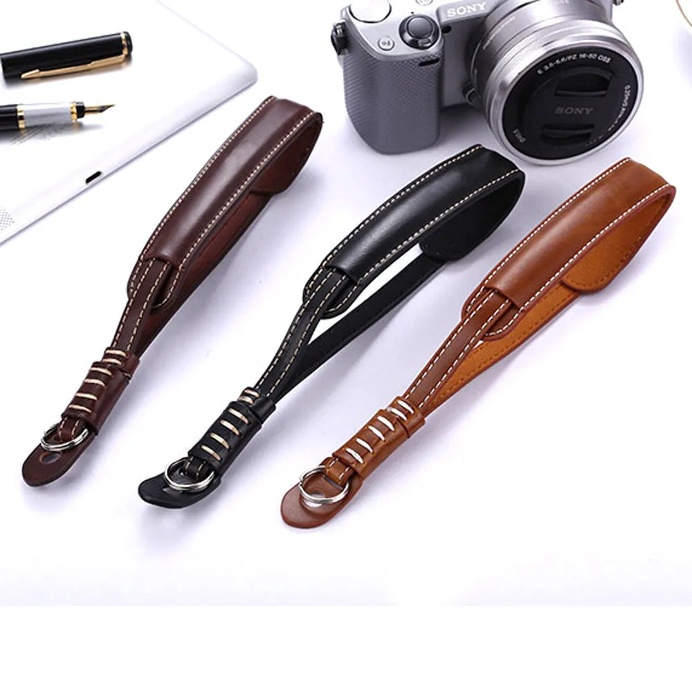 Black and brown universal wrist strap for SLR and mirrorless digital cameras.
