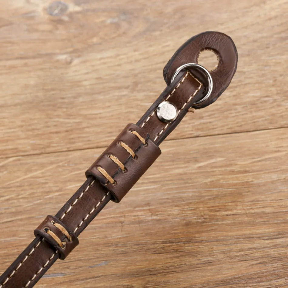 Black and brown universal wrist strap for SLR and mirrorless digital cameras.