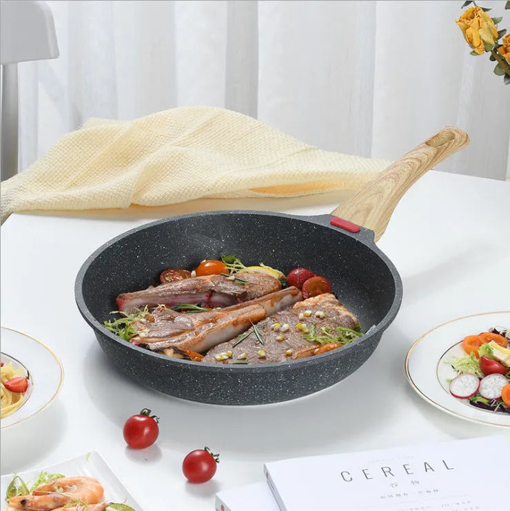 Korean style macadamite non-stick frying pan in green colour on a hob.