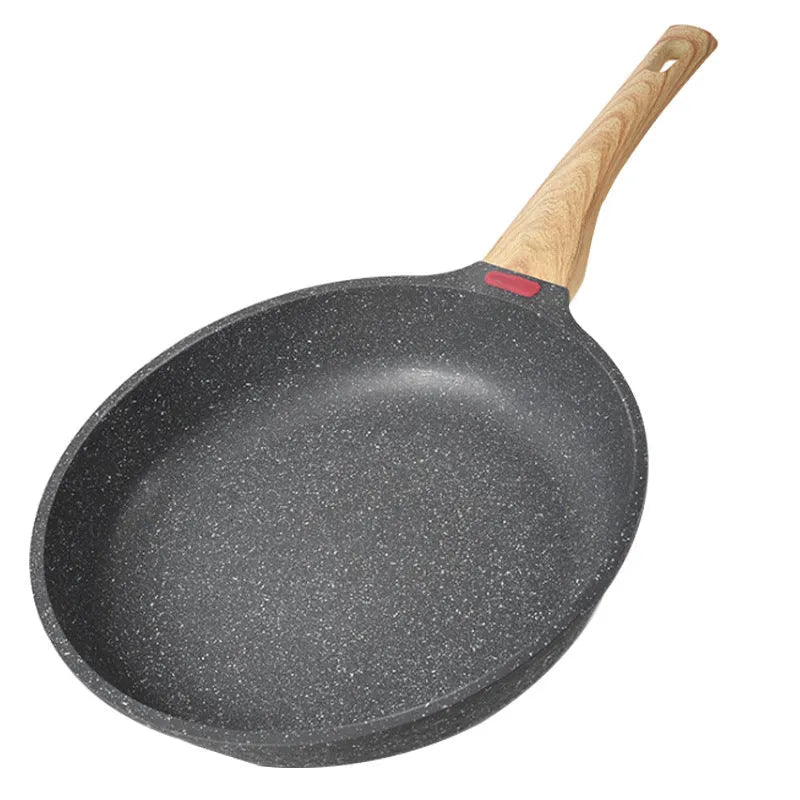 Korean style macadamite non-stick frying pan in green colour on a hob.