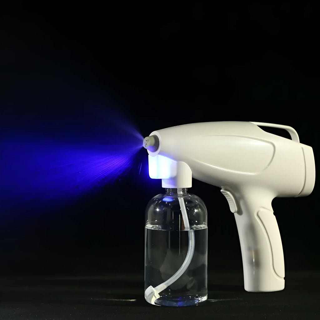 White handheld cordless electric disinfectant spray gun with bottle attached on a white background.