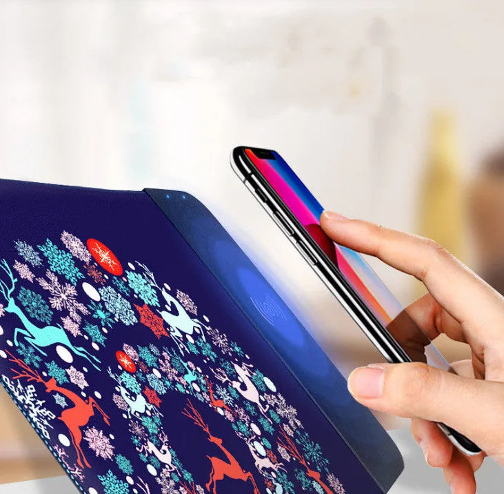 Cartoon design wireless charging mouse pad with RGB edge lighting on a desk