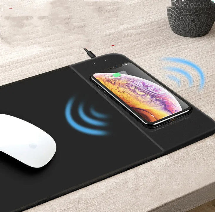 Cartoon design wireless charging mouse pad with RGB edge lighting on a desk