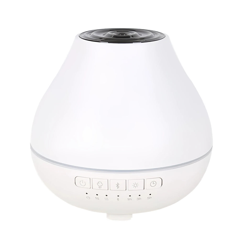 Round white Bluetooth humidifier and aroma diffuser with night light on a table.