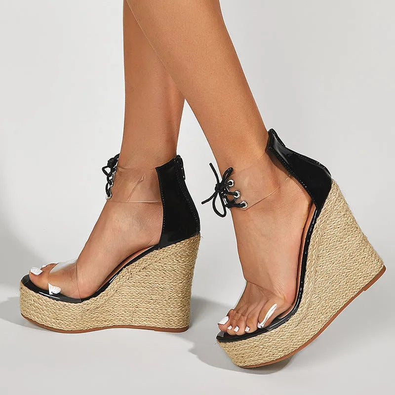 Black women's hemp rope wedge sandals with a high wedge heel and front tie fastening.