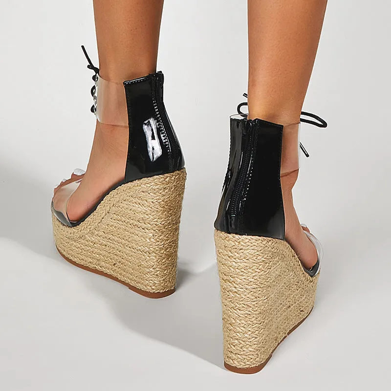 Black women's hemp rope wedge sandals with a high wedge heel and front tie fastening.