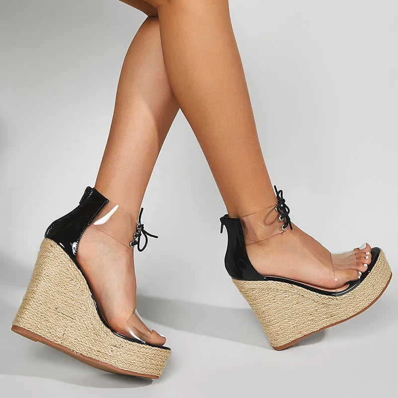 Black women's hemp rope wedge sandals with a high wedge heel and front tie fastening.