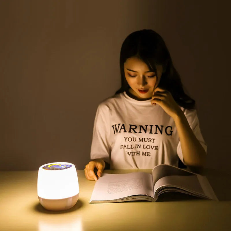 Pruixin rotating LED projector night light showing starry sky pattern projection on a wall.