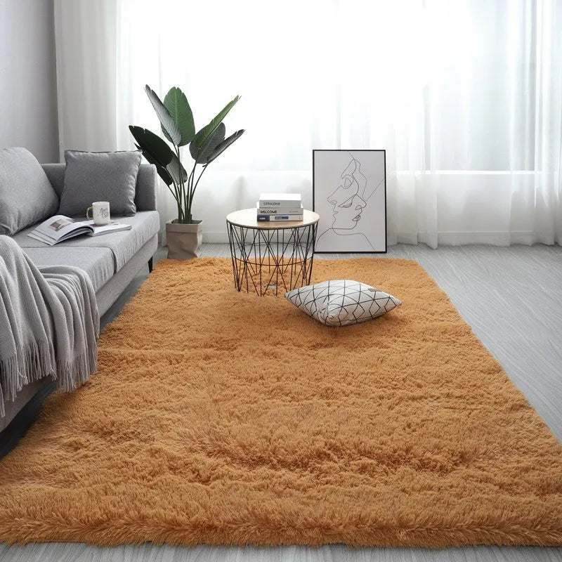 Large rectangle plush carpet in beige with anti-slip backing on wooden flooring