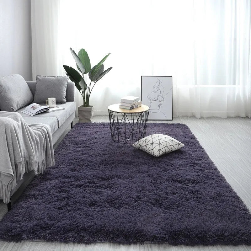 Large rectangle plush carpet in beige with anti-slip backing on wooden flooring
