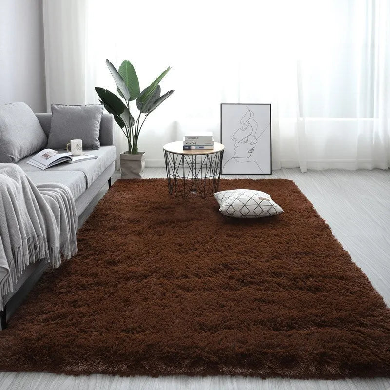 Large rectangle plush carpet in beige with anti-slip backing on wooden flooring