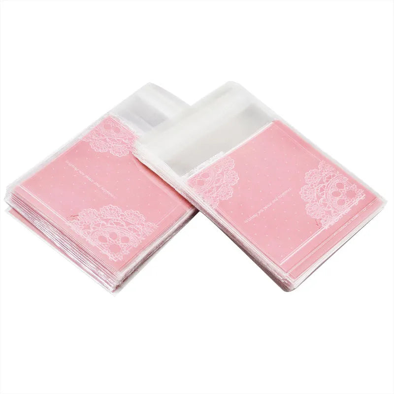 Clear pink self-adhesive plastic packaging bag with flap, shown next to a bar of soap.