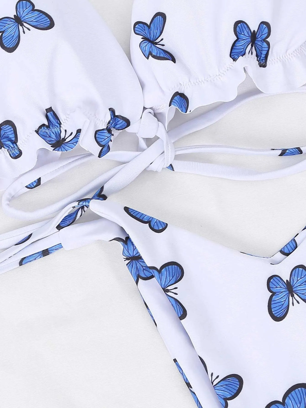 White butterfly print swimsuit with steel support top and lace thong bikini on display