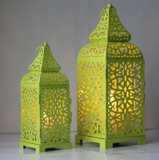 Blue retro geometric metal Moroccan-style candelabra holding a candle, showing hollow design.