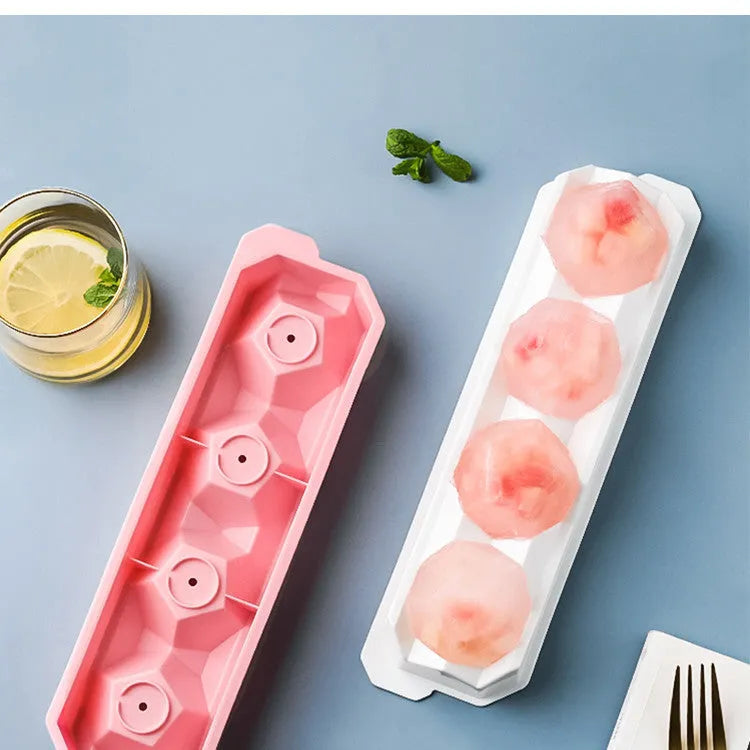 Silicone ice tray showing hockey puck, round, and pentagon shaped moulds in various colours
