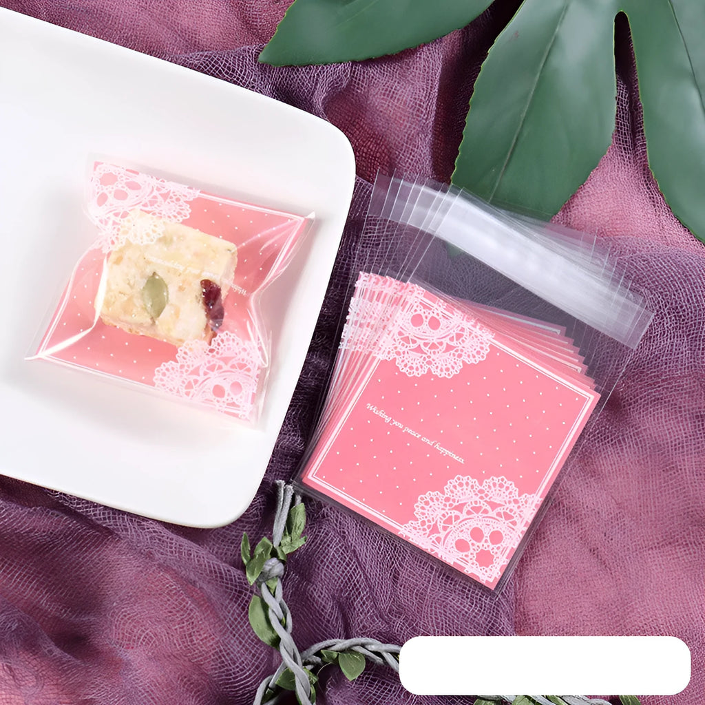 Clear pink self-adhesive plastic packaging bag with flap, shown next to a bar of soap.