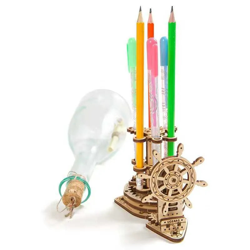 Ukrainian wooden model of a rotating steering wheel that functions as a pen holder on a desk.