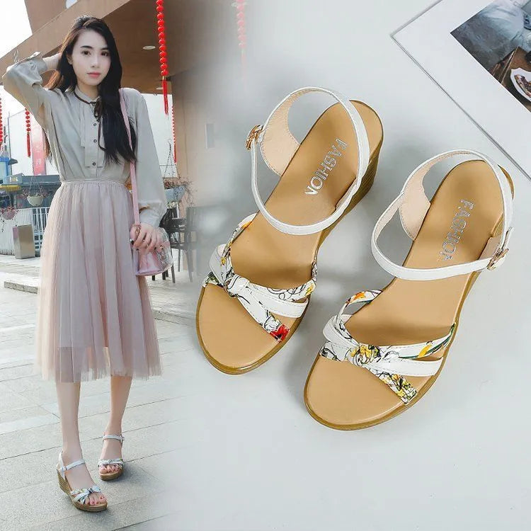 Pink women's wedge heel sandals with a fish mouth toe and buckle strap on a non-slip sole.