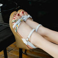 Pink women's wedge heel sandals with a fish mouth toe and buckle strap on a non-slip sole.